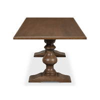 End view of wooden table with pedestal legs.