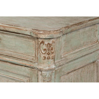 Detailed carving on sideboard corner.
