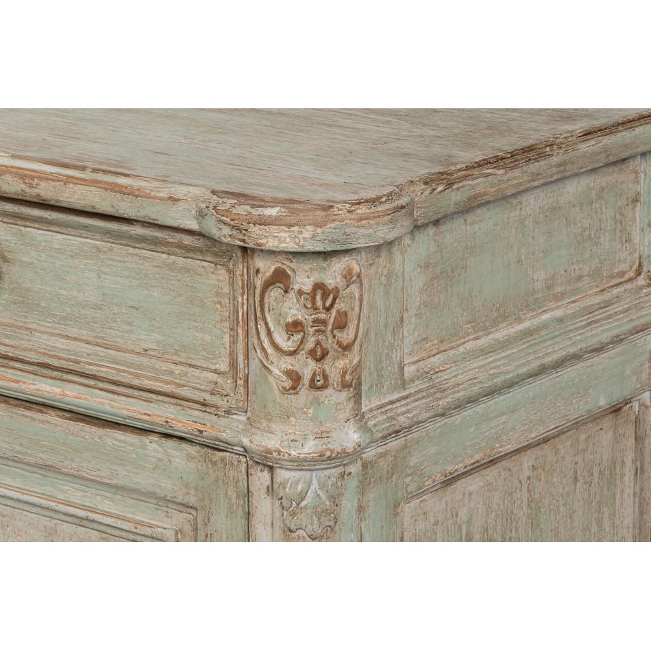 Detailed carving on sideboard corner.