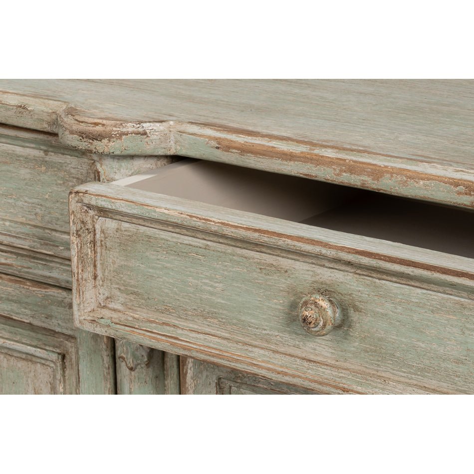 Drawer pulled open on French Provincial sideboard.