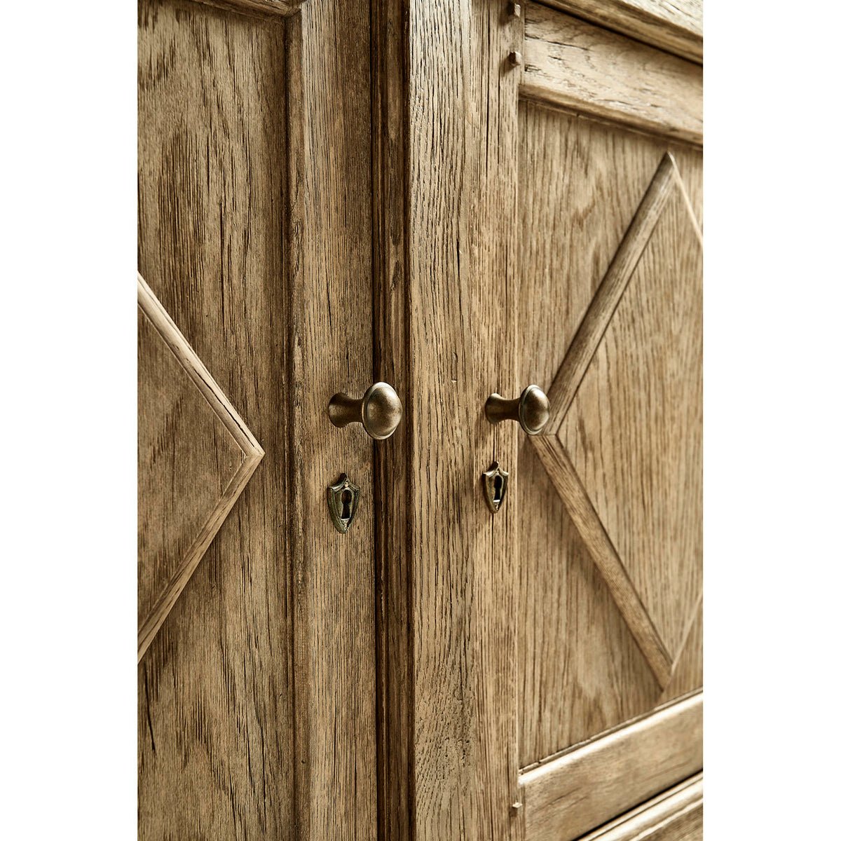 Close-up of sideboard doors with metal handles.