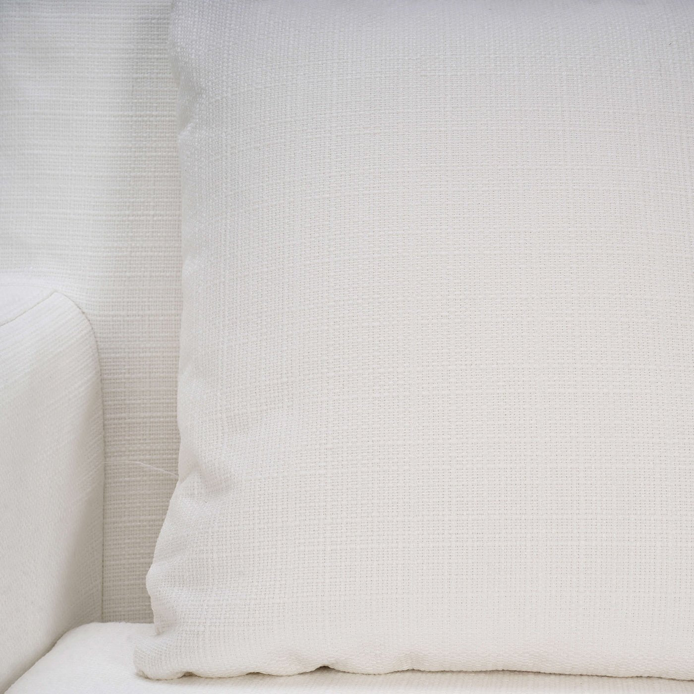 Detailed view of armchair cushion with textured fabric.