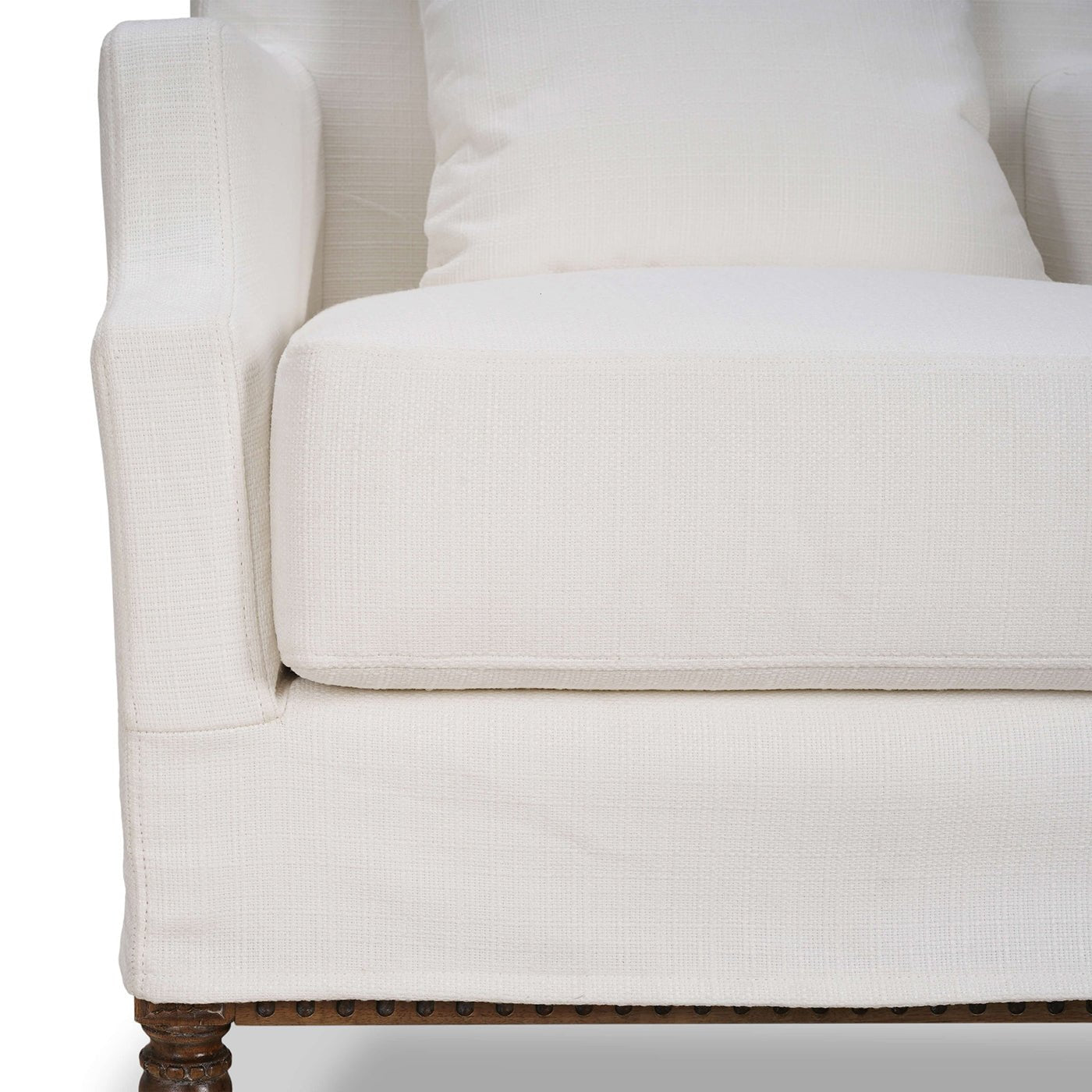 Close-up of armchair seat and cushion with slipcover.