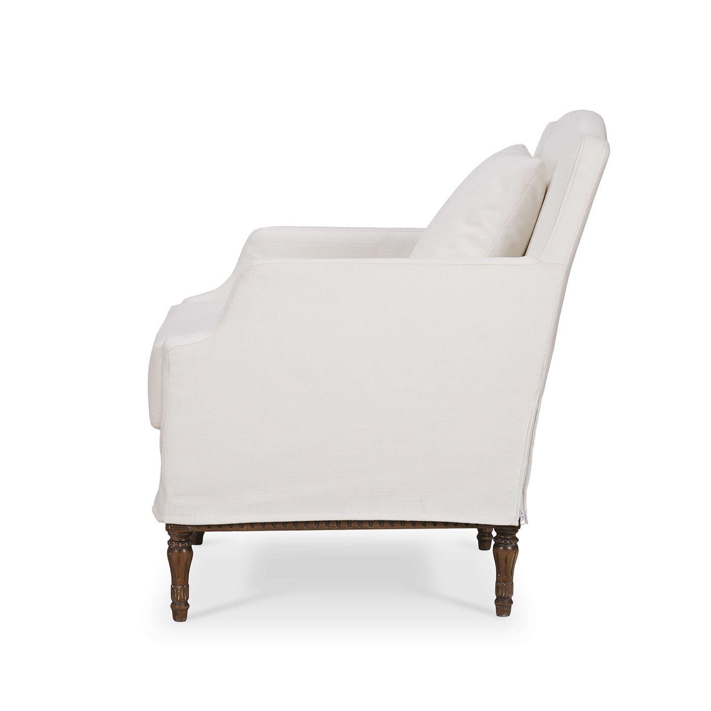 Side view of armchair with slipcover and cushion.