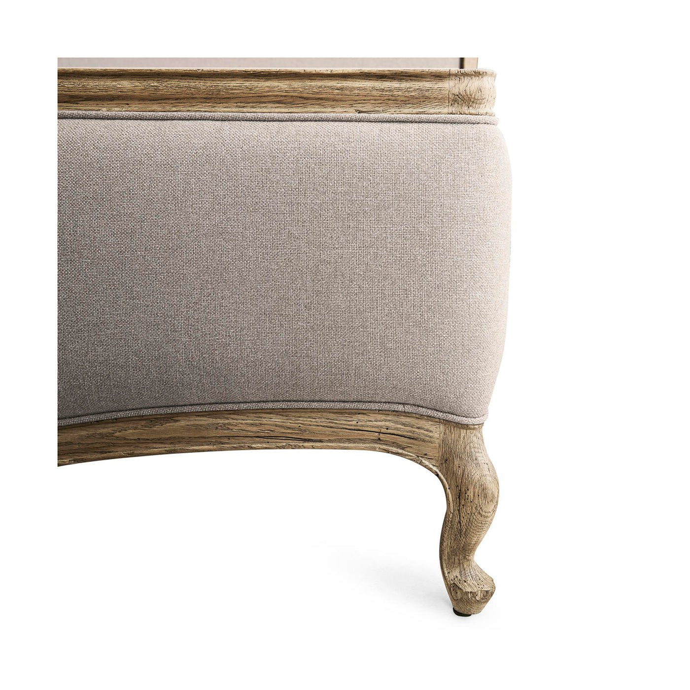 Footboard detail of French Provincial upholstered oak bed.