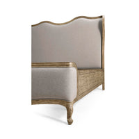 French Provincial bed corner with upholstery and wood.