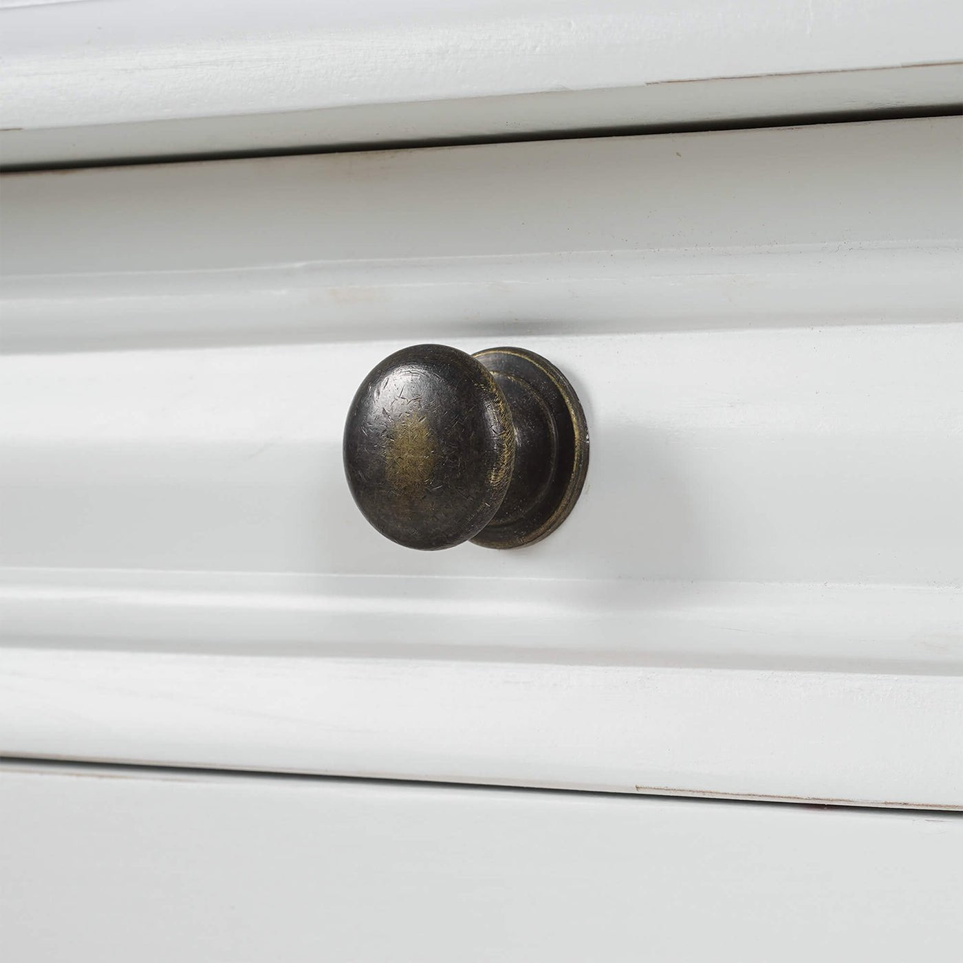 Close-up of knob on white end table drawer.