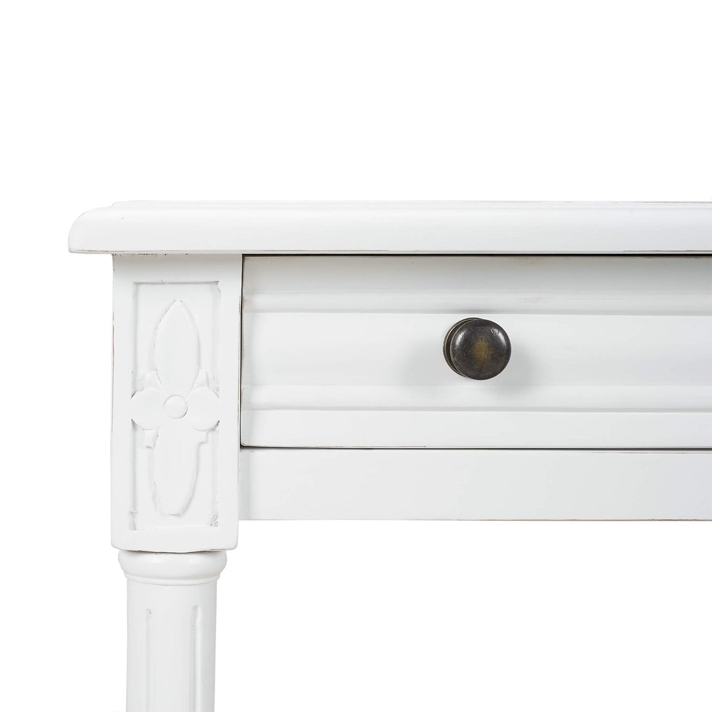 Close-up of carved detail on white end table.