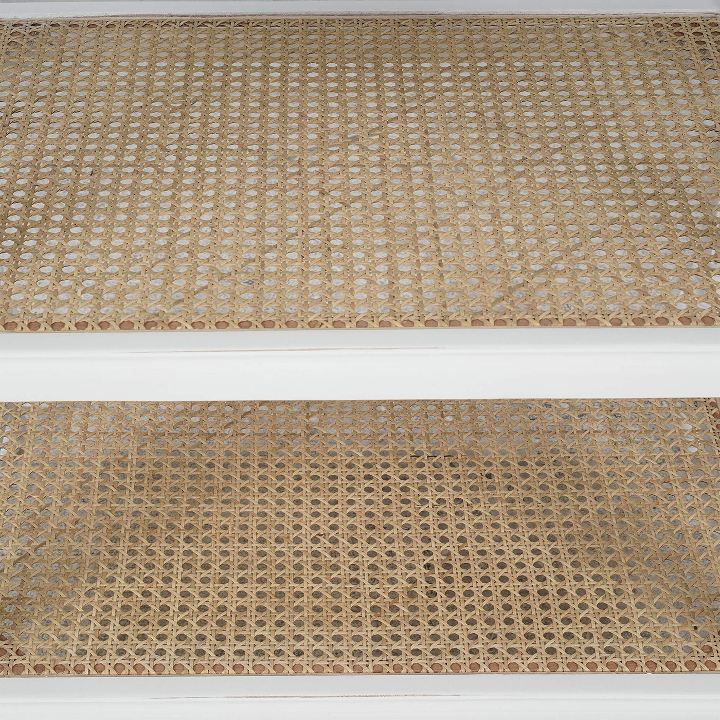 Rattan shelves on French Provincial white end table.