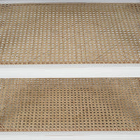 Rattan shelves on French Provincial white end table.