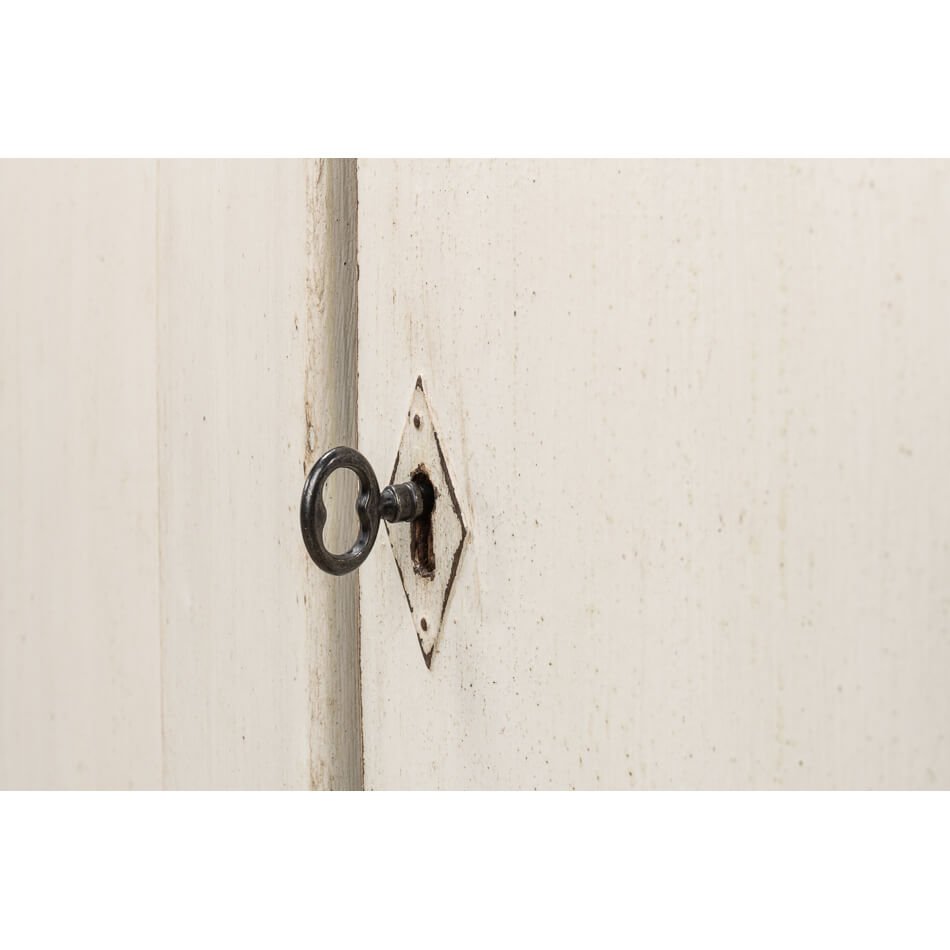 Close-up of keyhole on the sideboard door.