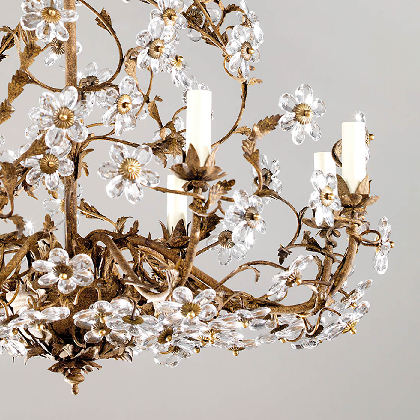 Close-up of crystal flowers on rustic chandelier.