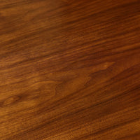 Wood grain detail on French walnut dining table surface.
