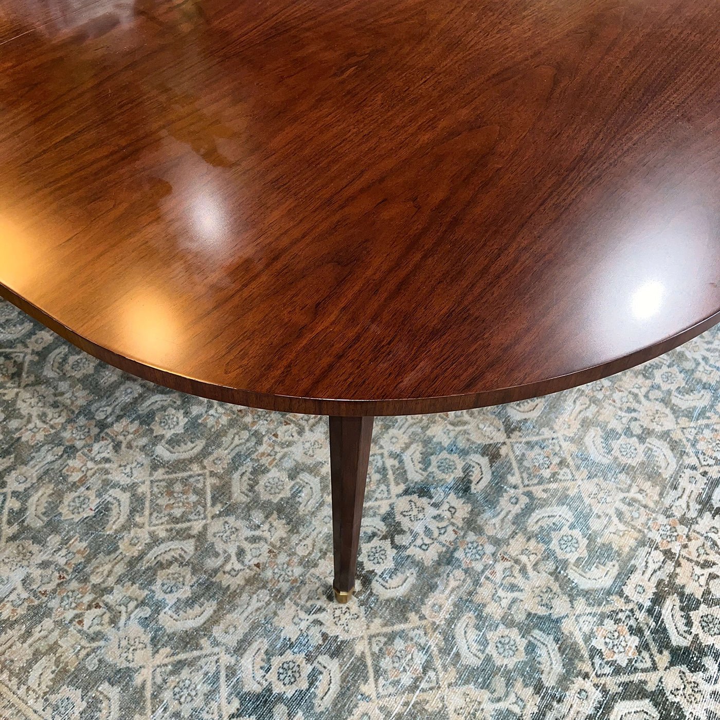 Smooth surface finish of French walnut dining table.