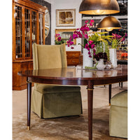 French walnut dining table with green chairs and decor.