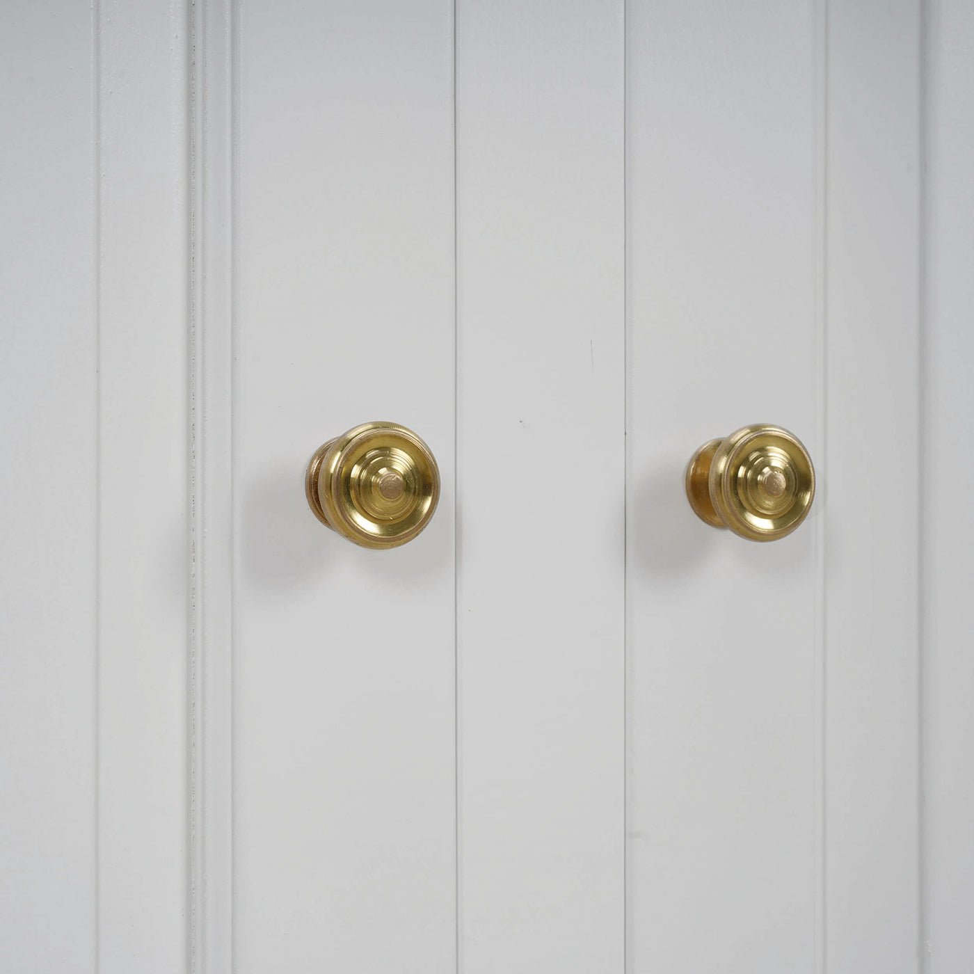 Close-up of cabinet brass knobs on doors.