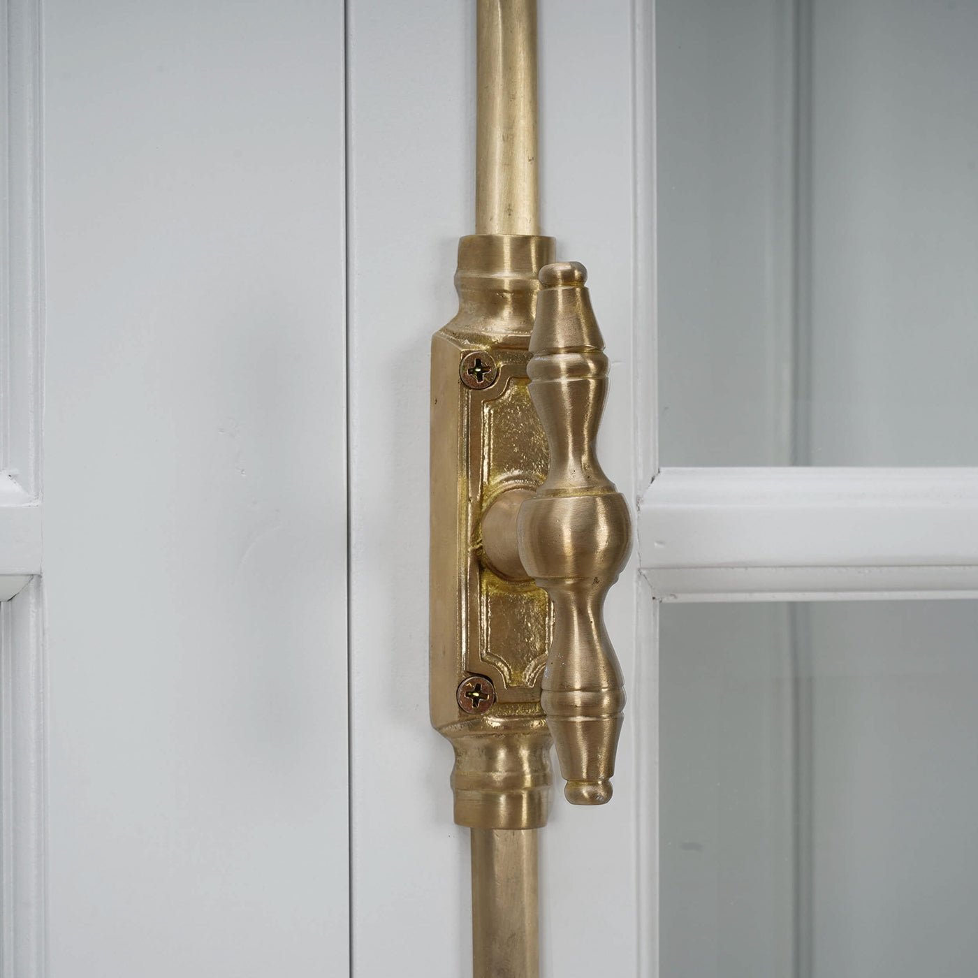 Close-up of display cabinet brass door latch.