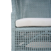 Cushion detail on frosted blue rattan dining chair.