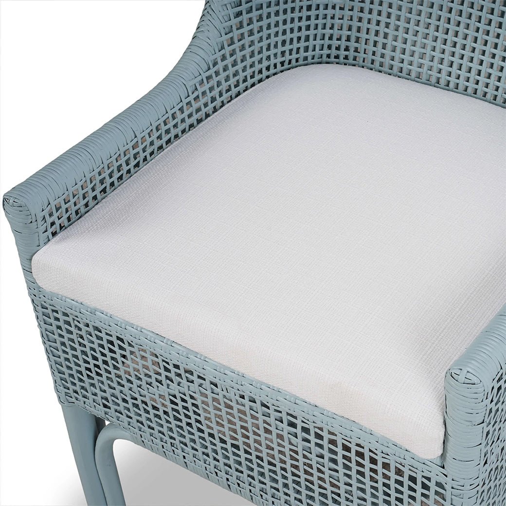 Close-up of cushioned seat on rattan dining chair.