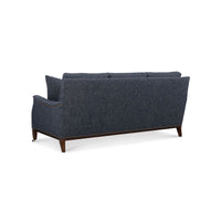 Rear angled view of blue Galvin Classic Sofa with wood detailing.