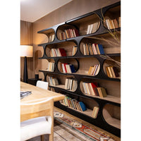 Two large bookcases with books, cozy room setting.