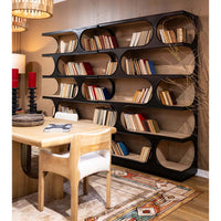 Large bookcase filled with books, dining room setting.
