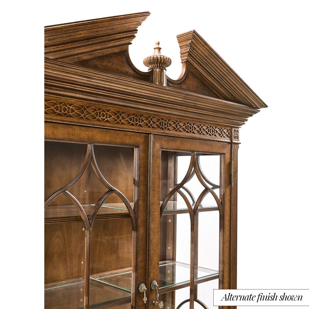 Close-up of decorative top on mahogany bookcase.