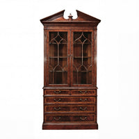 Closed George II mahogany bookcase with decorative top.