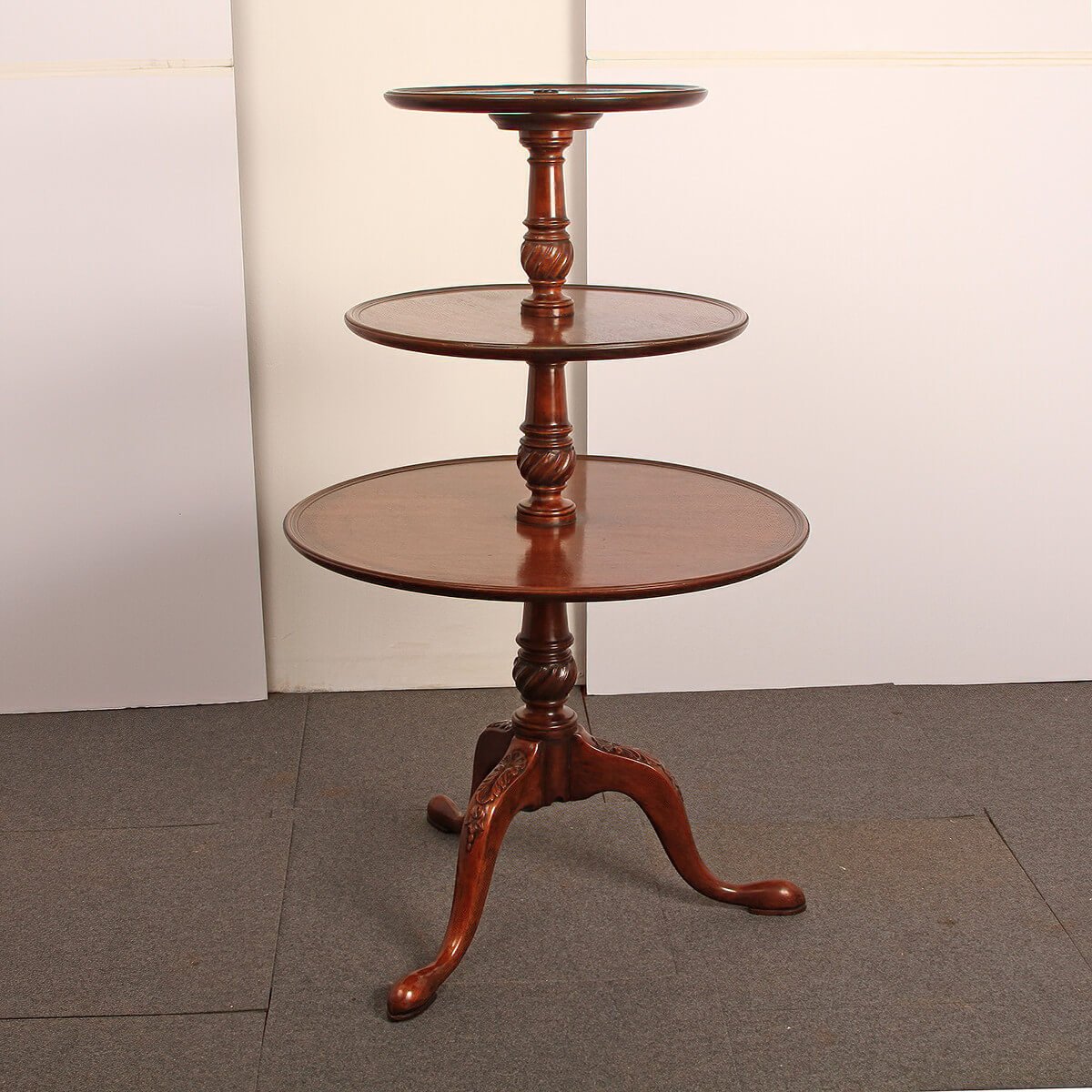 Mahogany dumbwaiter highlighting tier structure and design.