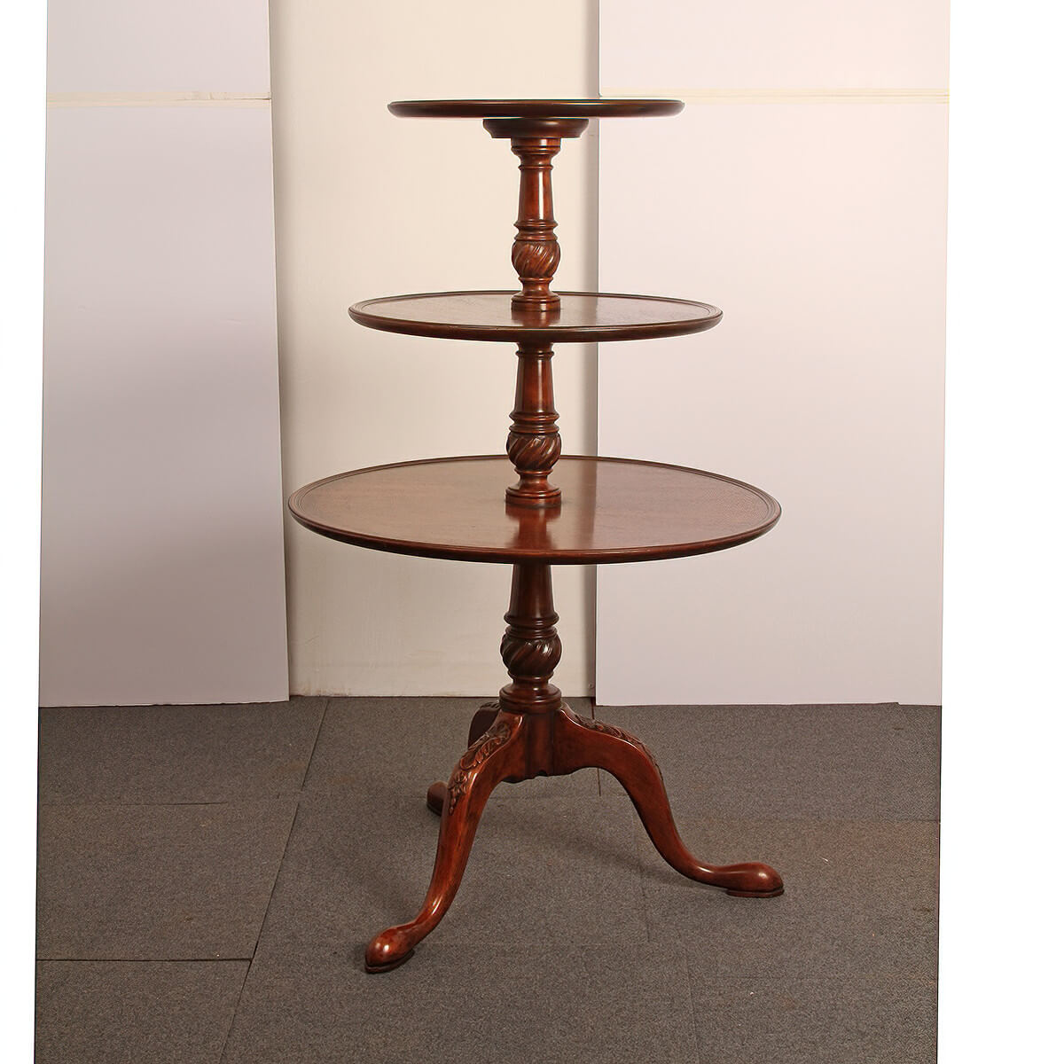Side view of mahogany dumbwaiter in room setting.