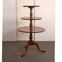 Side view of mahogany dumbwaiter in room setting.
