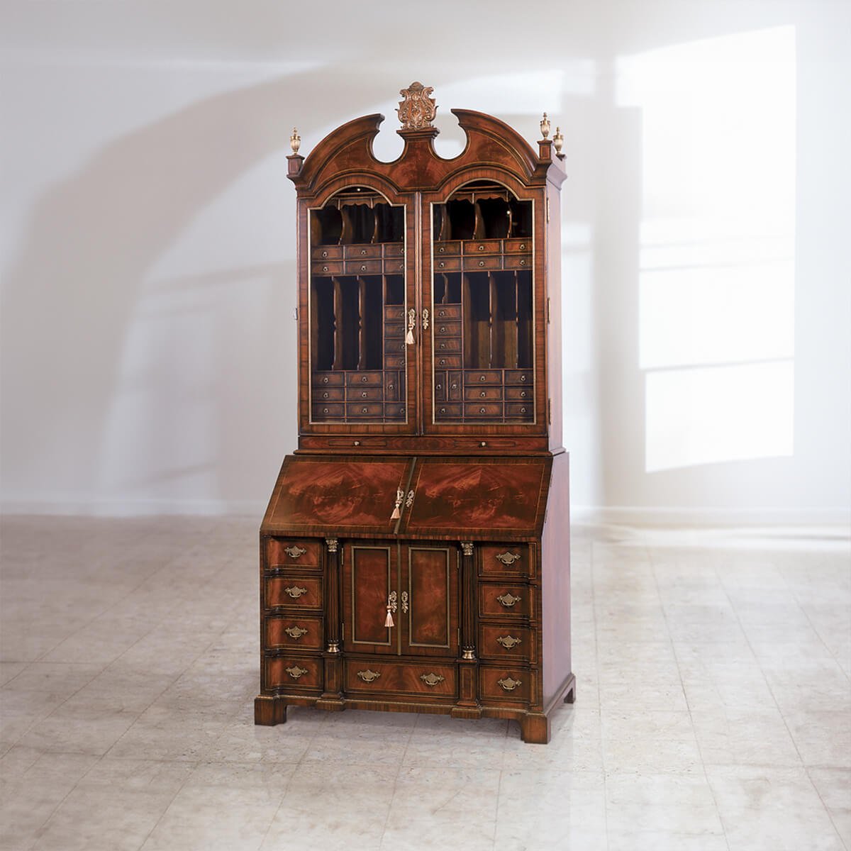 George II mahogany secretary bookcase in empty room.