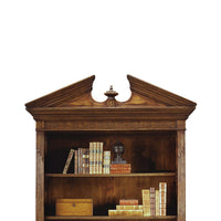 Detailed top view of walnut bookcase with decor.