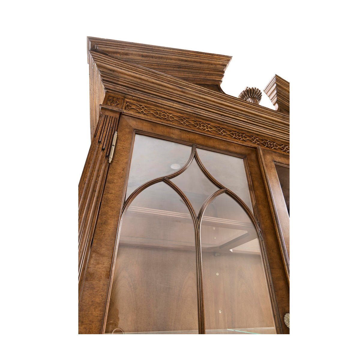 Close-up of glass detailing on walnut bookcase doors.