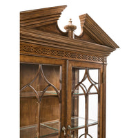 Close-up of ornate top detail on walnut bookcase.