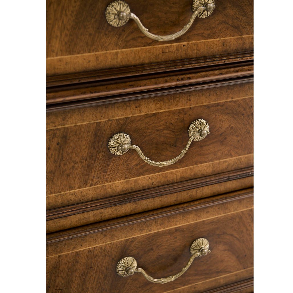 Close-up of drawer handles on walnut bookcase.