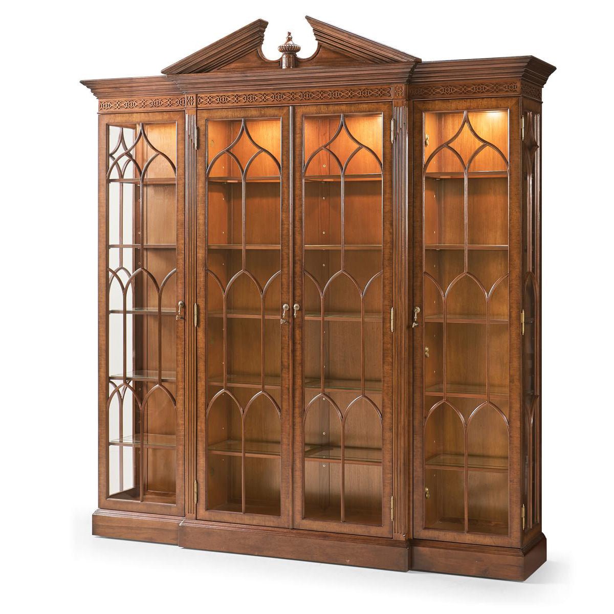 Illuminated walnut display bookcase with glass doors.