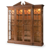 Illuminated walnut display bookcase with glass doors.