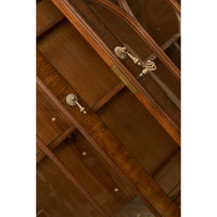 Detailed lock mechanism of walnut display bookcase.