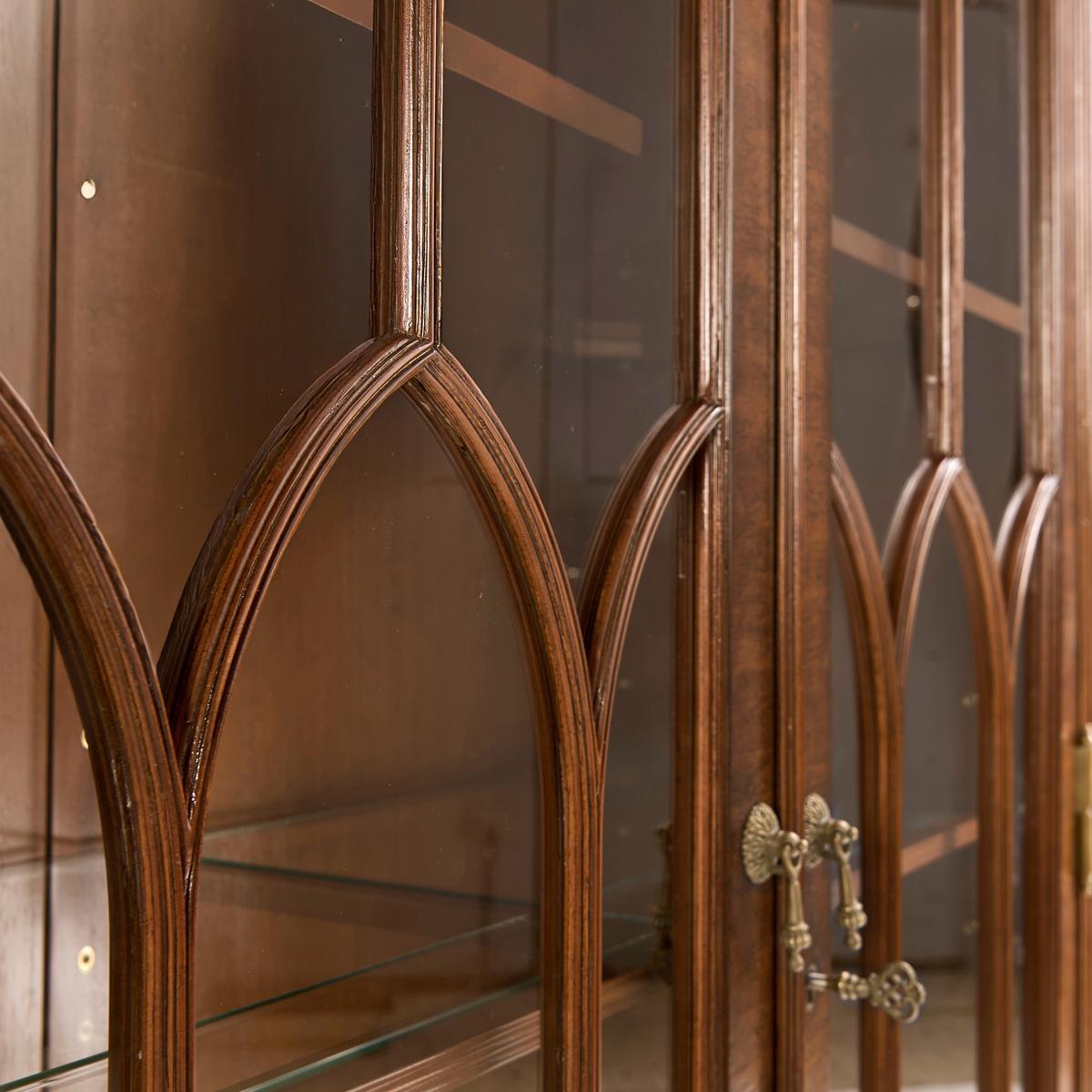 Close-up of glass door design on walnut display bookcase.