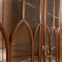 Close-up of glass door design on walnut display bookcase.