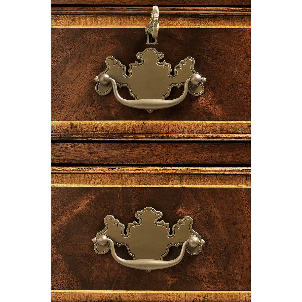 Detailed view of two antique-style dresser handles.