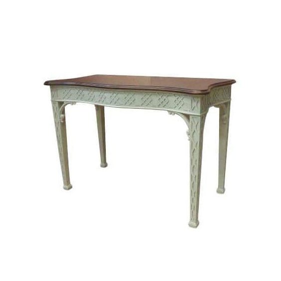 Elegant George III console table with intricate carved details.