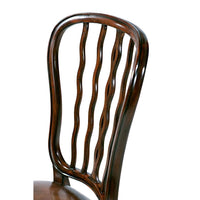 Close-up of mahogany chair backrest design.