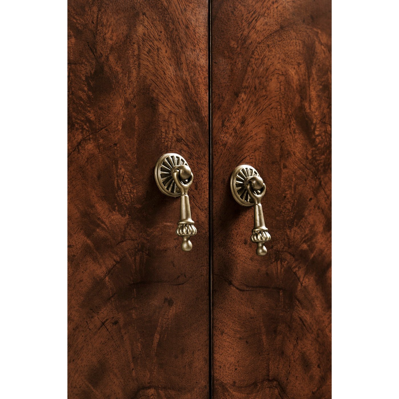 Sideboard door detail with decorative handle.