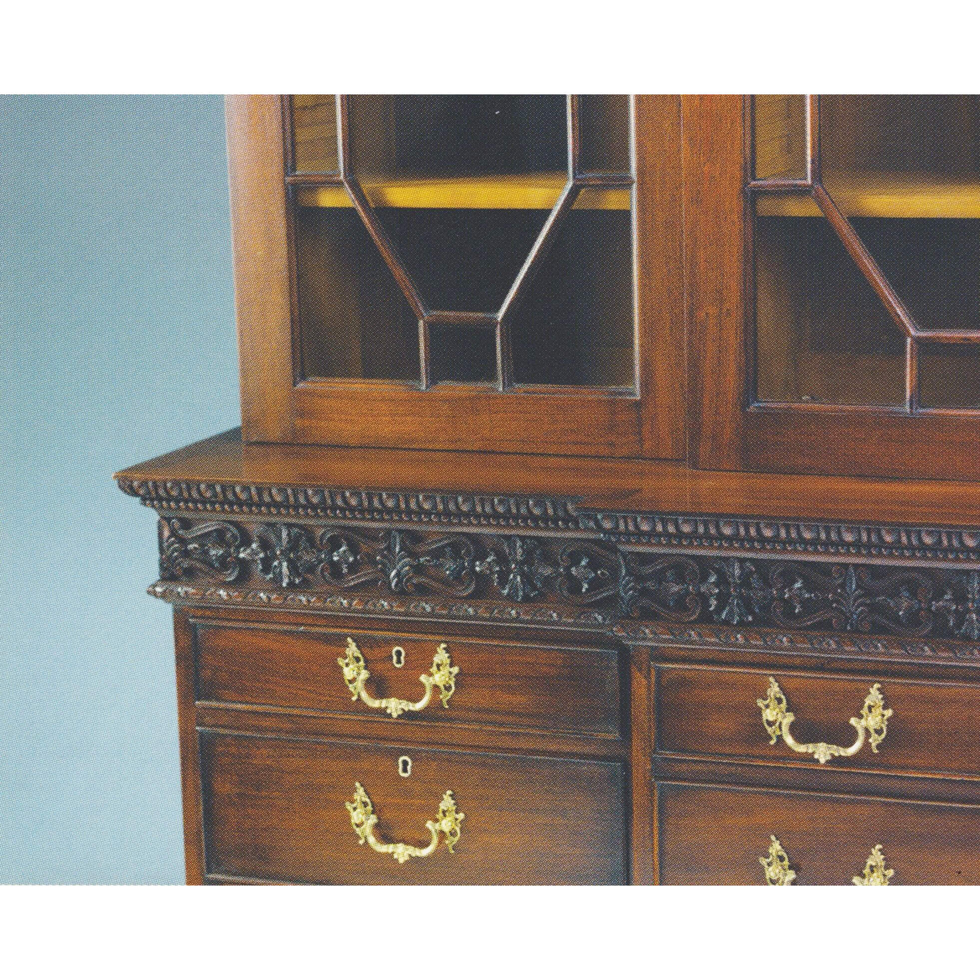 Close-up of bookcase drawers and carving details.