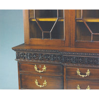 Close-up of bookcase drawers and carving details.