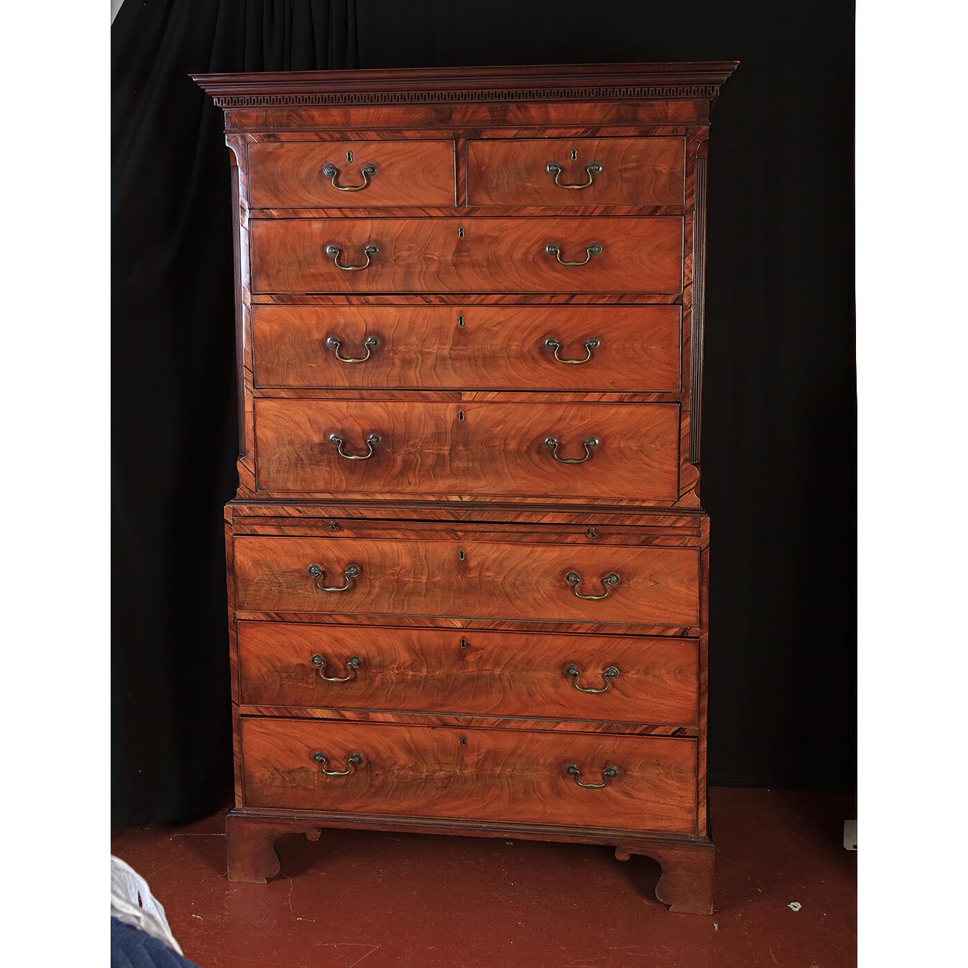 Mahogany chest on chest against dark background.