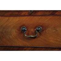 Close-up of handle on mahogany chest drawer.