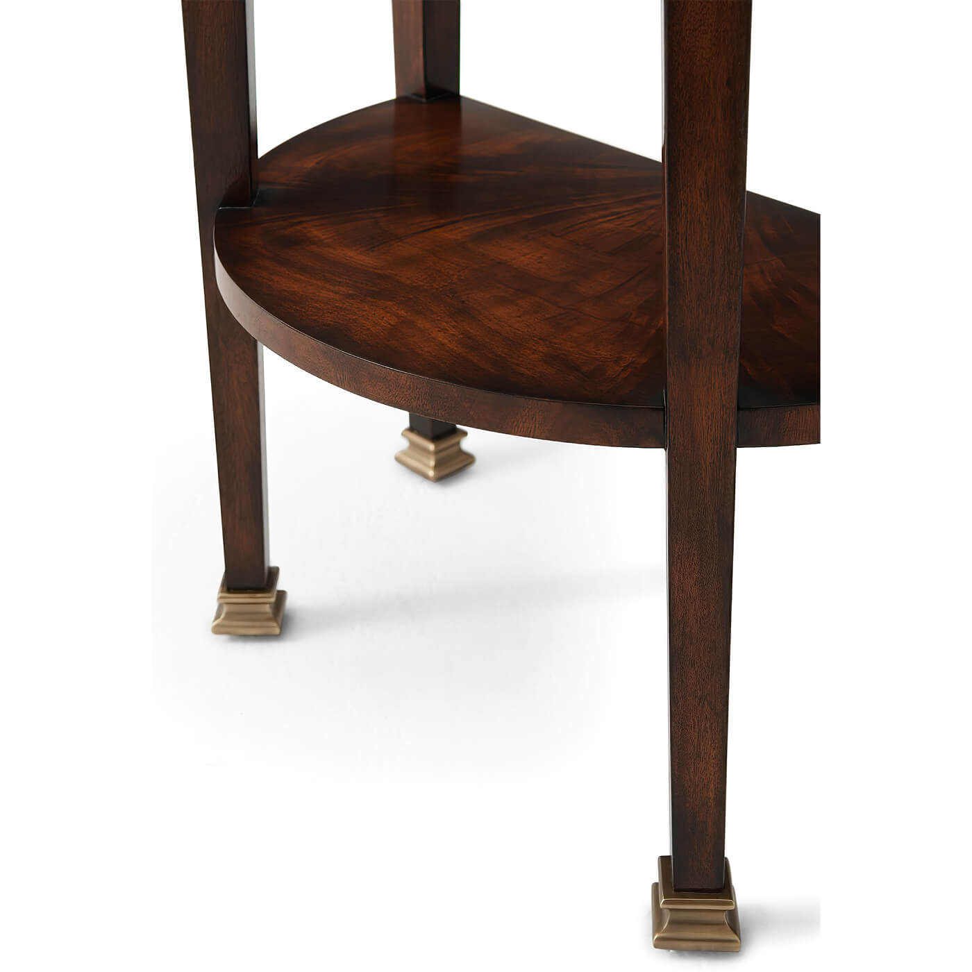 Leg details of mahogany demi lune console, brass feet visible.